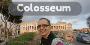 Mom wearing baby with colosseum